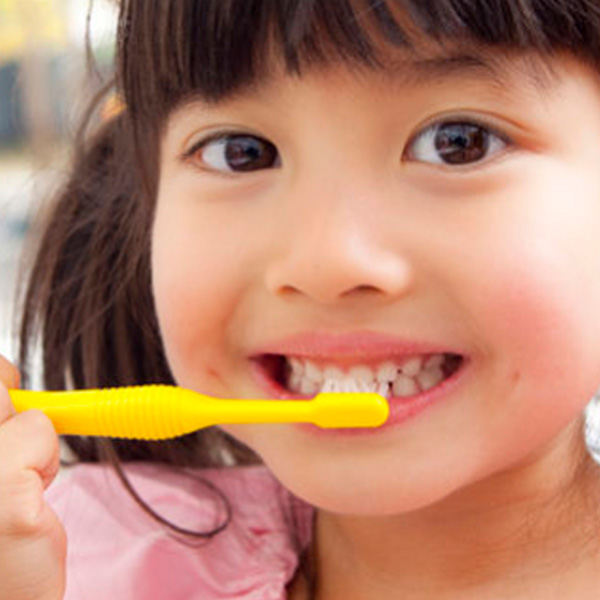 little girl brushing teeth